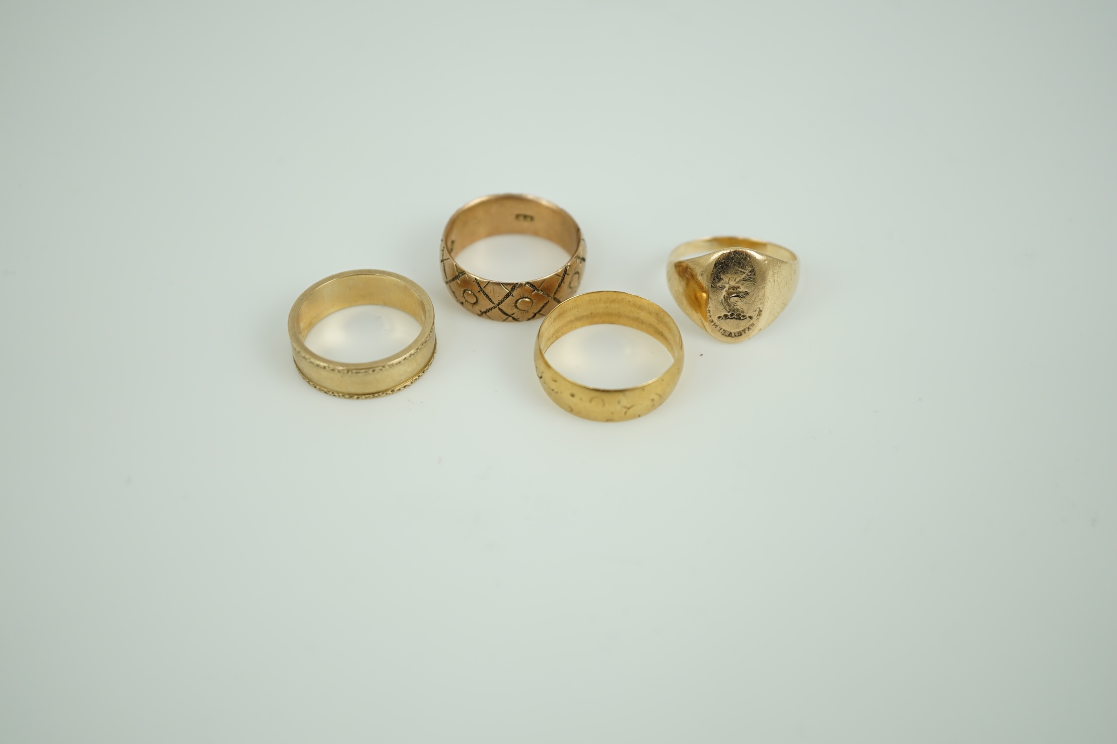 An 18ct gold wedding band, 4.3 grams, two 9ct gold wedding bands, 10 grams and a 14k intaglio signet ring, 3.9 grams.